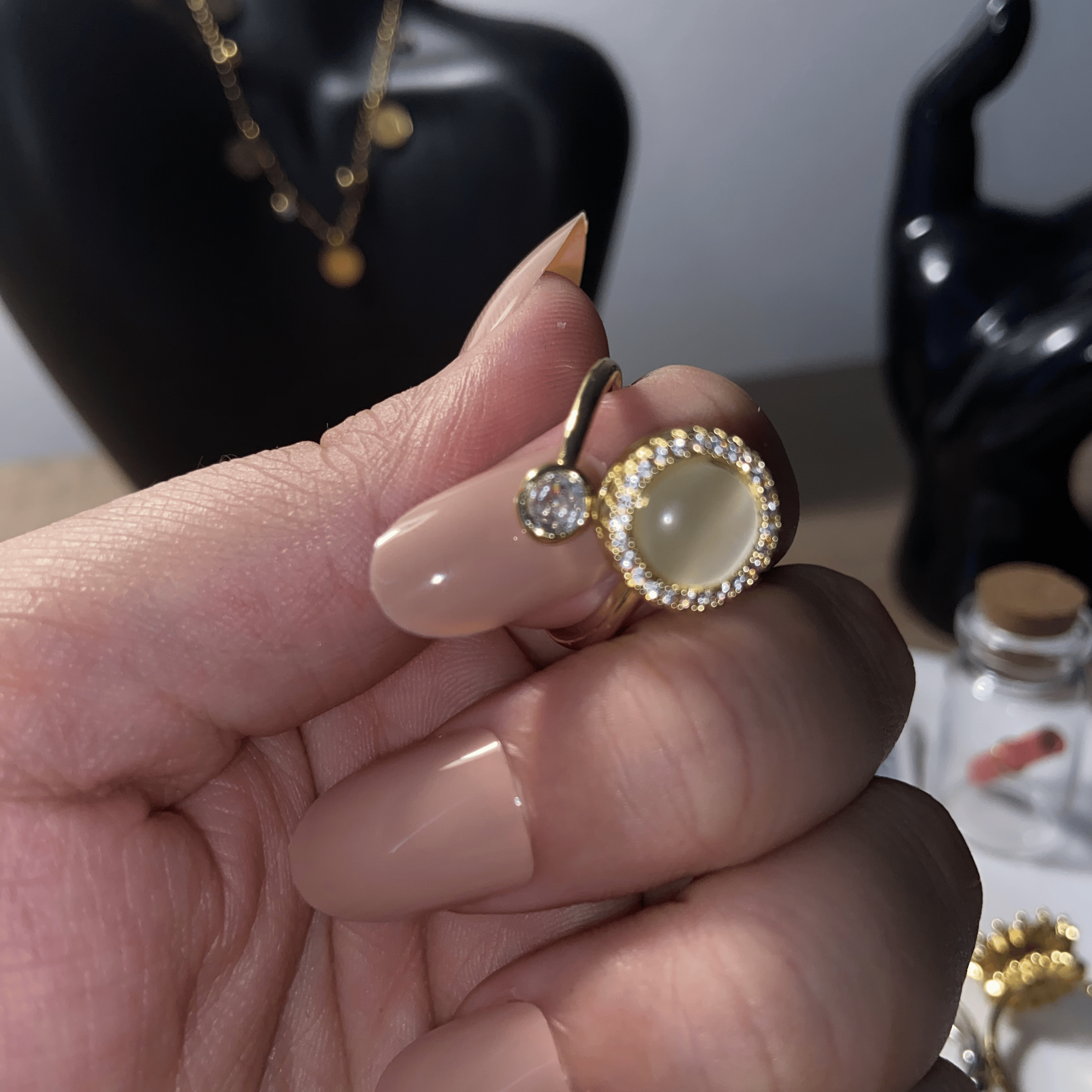 Close-up detail of the Alora adjustable pearl fidget ring with gold frame and stone.
