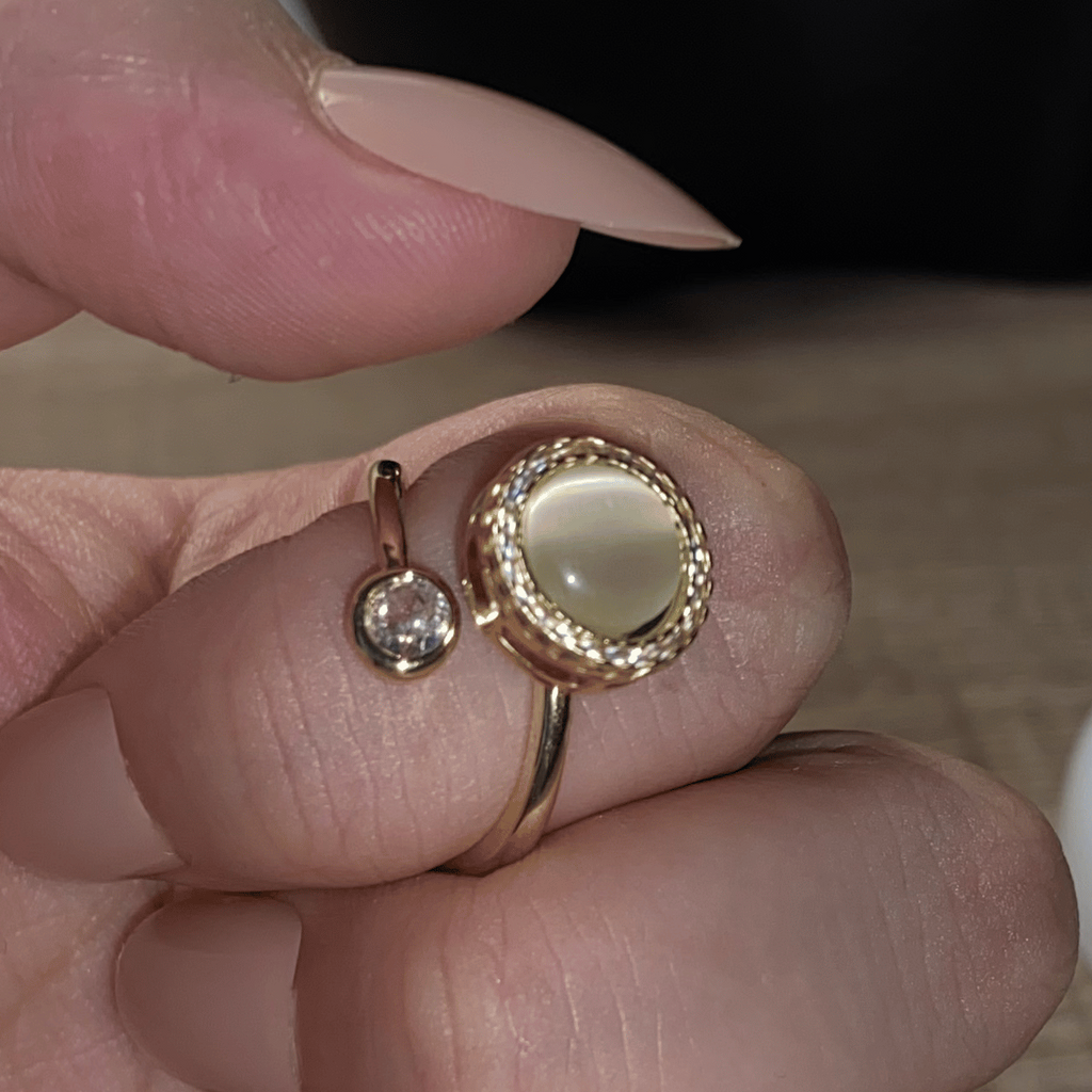 Elegant Alora pearl spinning ring being worn on a hand for calming focus.