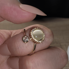 Elegant Alora pearl spinning ring being worn on a hand for calming focus.